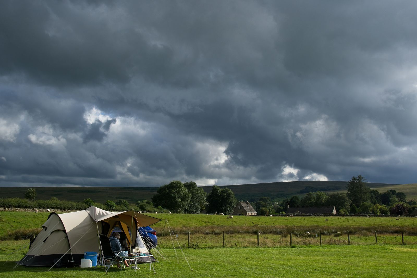 2 person hiking tent at a campsite in Northumberland, England, under dark storm clouds