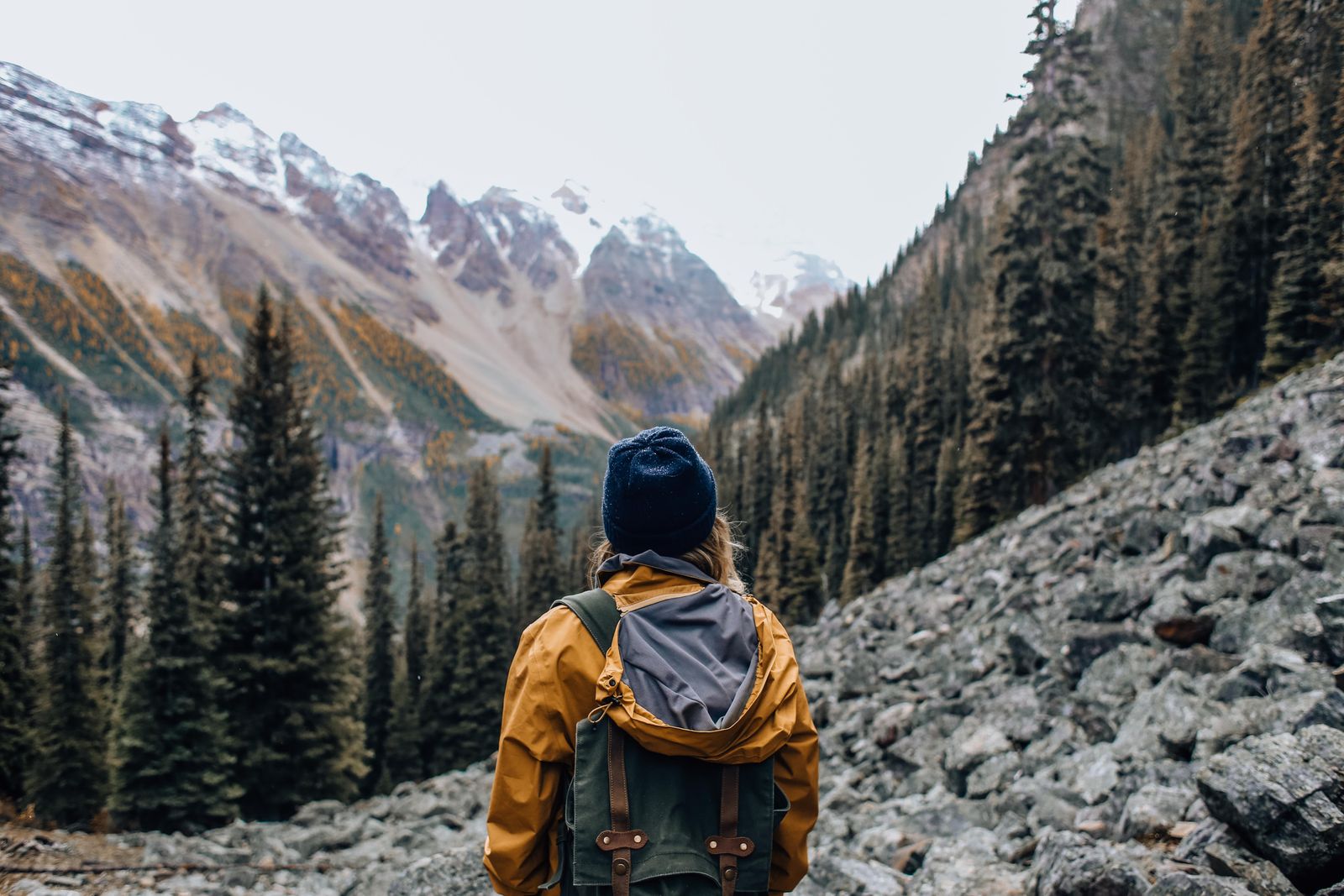 Hiker with a backpack on an exposed rocky mountainside, the kind of trail where the best sun hoodie for hiking matters