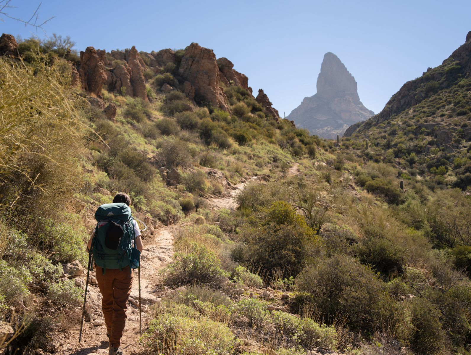 Woman hiking a footpath in Arizona's Superstition Mountains on a sunny day, a hot-weather test for ladies hiking shorts