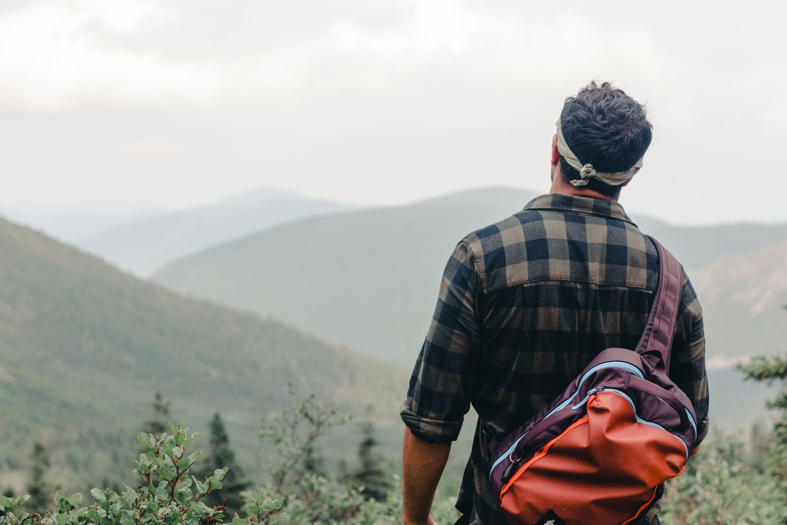 Backpacker with an overnight pack looking out at mountains, the kind of trip a Naturehike hiking kit suits